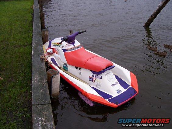 1994 Yamaha SJ700A Super Jet jet ski, white with red seat, docked at a wooden pier