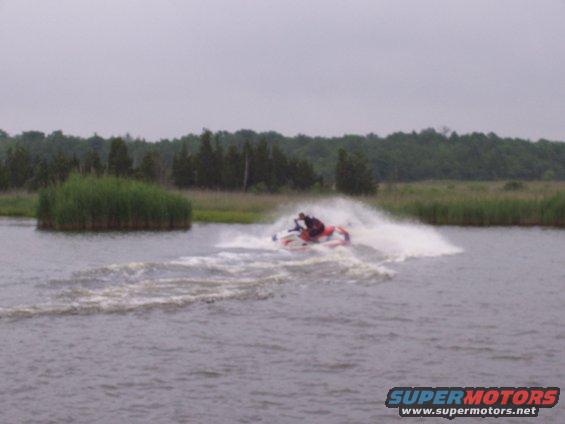 Jet ski on water with trees in background