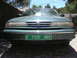 1996 Ford Crown Victoria - Front view of a green 1996 Ford Crown Victoria sedan, identified by its distinctive grille and body style.