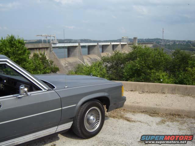 Gray 1988 Ford Crown Victoria LTD parked with a dam in the background