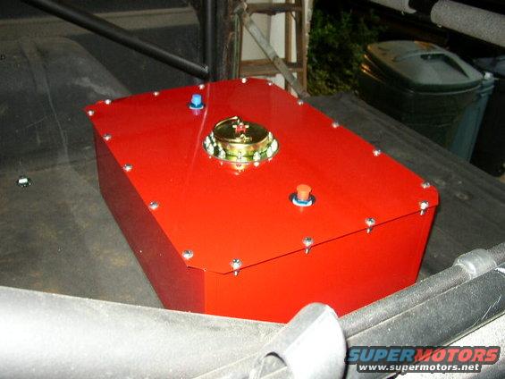 Red fuel cell with brass cap and blue and orange fittings