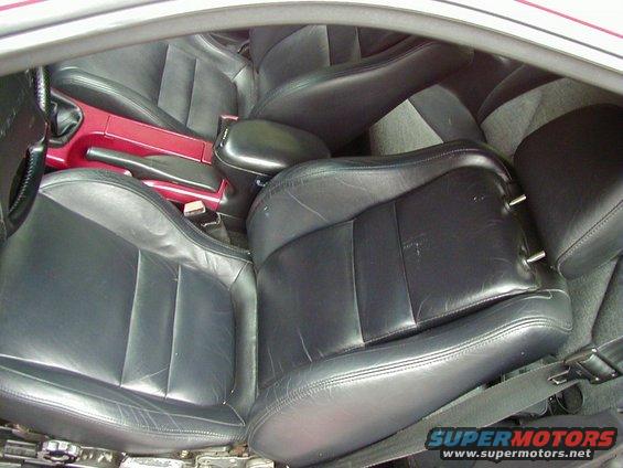 Black leather car seats and center console with red accents