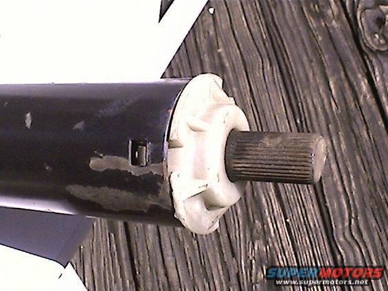 Black steering column with a white plastic housing and a splined shaft