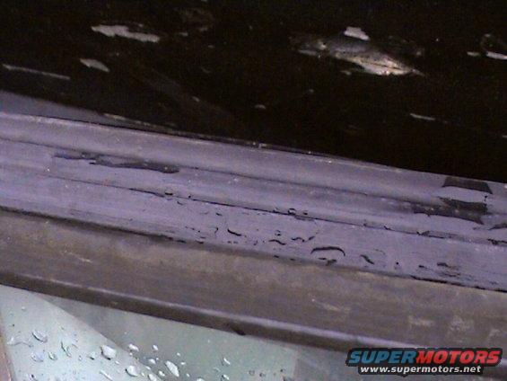 close-up of worn weather stripping on a vehicle's window frame