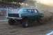 1994 Ford F-150 - This modified sedan, identified by its 'Fairlane' badge, is participating in an event, kicking up dust.