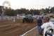 1994 Ford F-150 - A black 1994 Ford F-150 pickup truck competes on a dirt track at a fair with a Ferris wheel in the background.