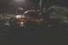 1994 Ford F-150 - A modified Dodge Ram pickup truck emits dark smoke while driving at night.