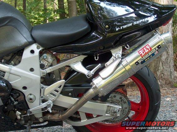 Close-up of a motorcycle's Yoshimura exhaust and rear wheel