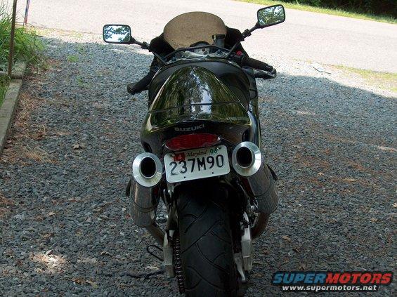 Black motorcycle rear view with dual exhaust pipes and Maryland license plate 237M90