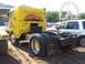 1994 Ford F-150 - A yellow semi-truck cab with a mural on its side is parked next to a white SUV, with a Ferris wheel in the background.