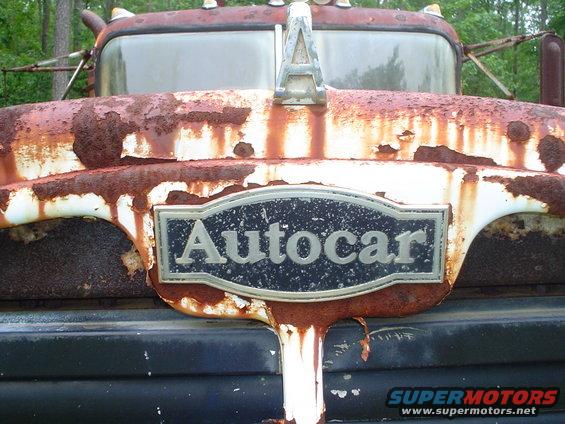 Rusted Autocar truck grille with a silver hood ornament