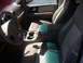 2003 Ford Expedition - The interior of a 2003 Ford Expedition features tan leather seats and a beige dashboard.