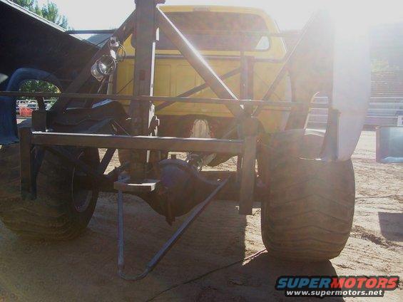 Rear view of a heavily modified truck with large tires and exposed axle components