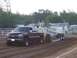 1994 Ford F-150 - A maroon 1999 Chevrolet Silverado truck competes in a pull event, dragging a trailer with "TERMINATOR" written on its side.