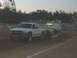 1994 Ford F-150 - White Chevrolet Silverado truck pulls a sled at a dirt track event with a Ferris wheel visible.