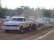 1994 Ford F-150 - A modified pickup truck competes in a tractor pull event, dragging a weighted sled.