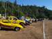 1994 Ford F-150 - Several trucks and a yellow Corvette are parked at an outdoor event.
