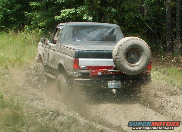 1988 Ford Bronco rear view driving through mud