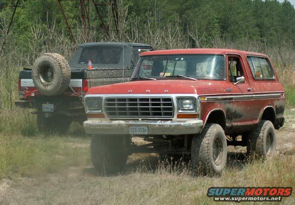 Red Ford Bronco with a prominent grille and a license plate reading XZB-3326