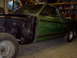 1970 Ford Ranchero - A green 1970 Ford Ranchero is shown in a garage with its front fender removed, revealing the chassis and engine bay.