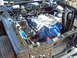 1970 Ford Ranchero - The engine bay of a vehicle, a blue Ford V8 engine with chrome valve covers.