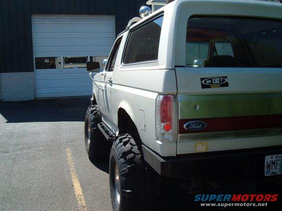 White 1989 Ford Bronco rear view with lifted suspension and large tires