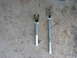 1995 Ford Bronco - Two tie rod separator tools of different sizes are shown on a concrete floor.