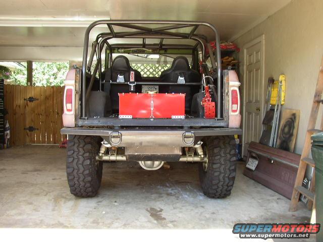 Modified Ford Bronco rear view, showing roll cage, racing seats, and custom bumper