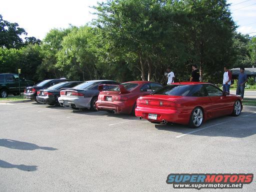 Red 1994 Ford Probe rear view with spoiler and custom wheels