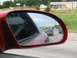 1994 Ford Probe - Highway traffic viewed through a side mirror, with a warning about object proximity.