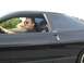 1994 Ford Probe - Driver in sunglasses behind the wheel of a black 1994 Ford Probe.