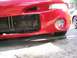 1994 Ford Probe - Front view of a red 1994 Ford Probe, showing the bumper, fog light, and radiator.