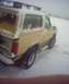 1984 Ford Bronco - A 1984 Ford Bronco is seen covered in snow, parked outdoors in a winter landscape.