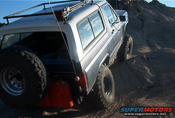 Ford Bronco with spare tire and jerry can on rocky terrain