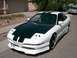 1996 Ford Probe - A modified 1996 Ford Probe with a custom body kit and racing stripes is parked on a residential street.