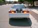 1996 Ford Probe - White 1996 Ford Probe with black racing stripes parked on a residential street.