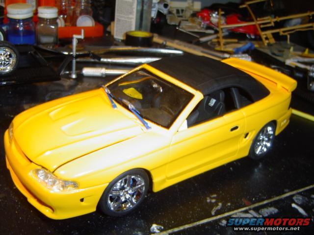 Yellow convertible model car with black top and chrome wheels