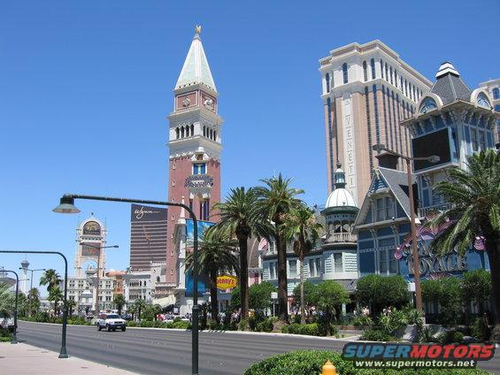 White sedan on Las Vegas Strip with Venetian architecture