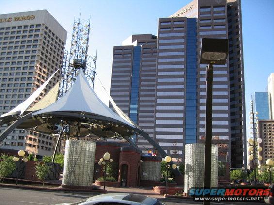 City street with Wells Fargo building, modern skyscrapers, and a large white tent structure