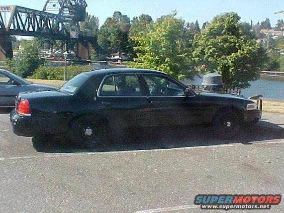 Black 1999 Ford Crown Victoria sedan, side view