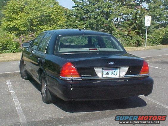 Rear view of black Ford Crown Victoria sedan parked in lot