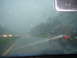 1998 Volkswagen Jetta - Driving in the rain, the view from inside the car shows other vehicles on the road ahead.