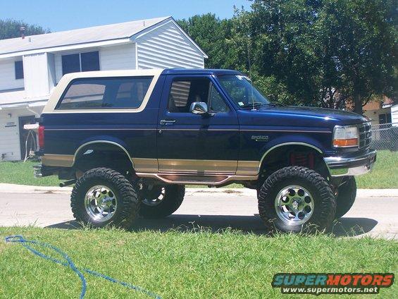1995 Ford Bronco lifted with chrome wheels and tan trim