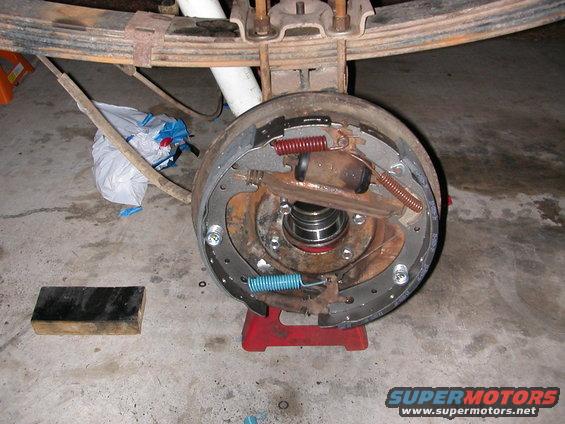 close-up of a vehicle's rear drum brake assembly with new parts installed