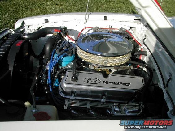 Close-up of a Ford Racing engine with a chrome air cleaner and valve covers