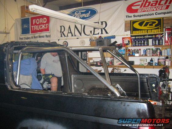 Roll cage inside black SUV interior