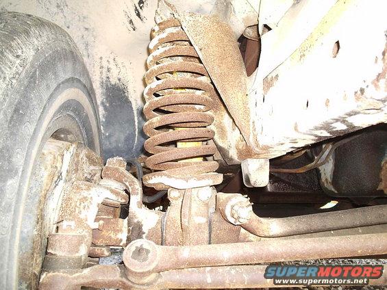 Front suspension coil spring and tire of a 1979 Ford F-150