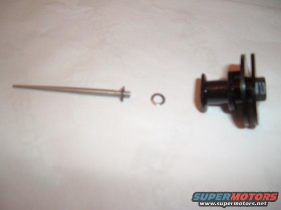 metal rod, washer, and black plastic component laid out on white surface