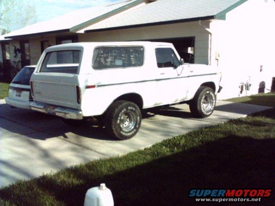 White 1978 Ford Bronco parked in driveway, rear 3/4 view