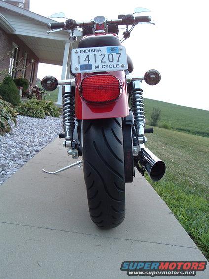 Rear view of a red motorcycle with an Indiana license plate